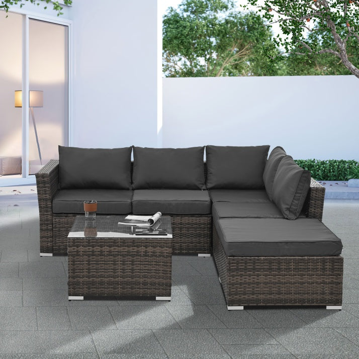 Patio Furniture 4-Piece Set – Seasonal PE Wicker Outdoor Sofa with Tempered Glass Coffee Table & Ottoman (Brown)